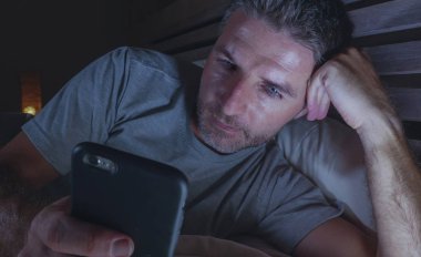 geç gece karanlık ışık cep telefonuyla internet bağımlılığı ve yaşam tarzı kavramı içinde sosyal medya online app zevk yatakta yatarken ağ ev yatak odası, genç çekici ve rahat adam