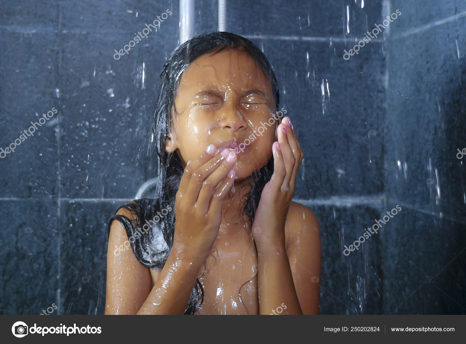 Smiling young girl bathing under a shower at home. Beautiful teen girl  taking shower and washing in the bathroom. Happy child washing head, face  and body with water. Stock Video