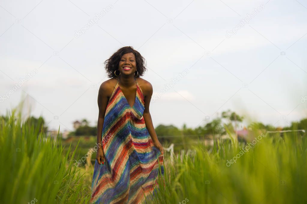 lifestyle portrait of young attractive and happy black afro American woman posing cheerful having fun outdoors at beautiful rice field background enjoying holidays trip 