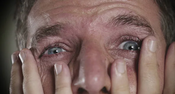 Dramatic portrait of young man with expressive eyes crying desperate  in fear and horror feeling anxious and depressed feeling despair and sadness emotion — Stock Photo, Image