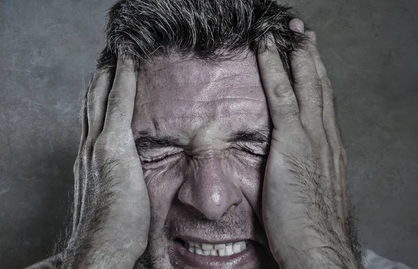Head and shoulders dramatic portrait of young man crying in pain suffering depression and anxiety problem feeling stressed and desperate in looking devastated — Stock Photo, Image