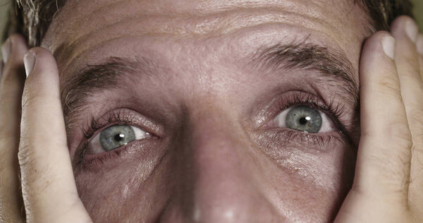  dramatic portrait of young man with expressive eyes crying desperate  in fear and horror feeling anxious and depressed feeling despair and sadness emotion 