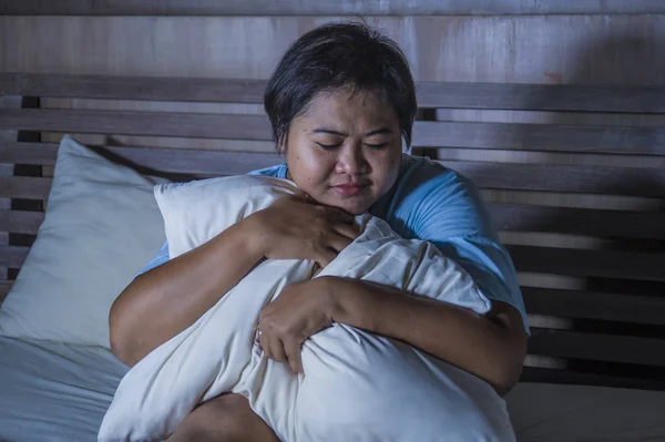 Young sad and depressed fat and chubby Asian girl feeling upset and desperate crying on bed at home victim of bullying and discrimination for her plus size and overweight — Stock Photo, Image