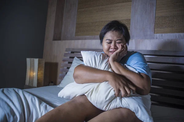 Young sad and depressed fat and chubby Asian girl feeling upset and desperate crying on bed at home victim of bullying and discrimination for her plus size and overweight — Stock Photo, Image