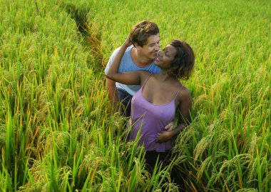 Genç, mutlu, güzel, etnik kökenli bir çift. Siyahi Afrikalı Amerikalı bir kadın ve beyaz bir erkek. Sarılıp, tatillerde eğleniyorlar.