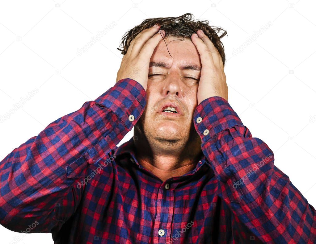 stressed and overwhelmed 30s or 40s white man holding head with hands in crazy stress and frustrated face expression looking to camera suffering problem