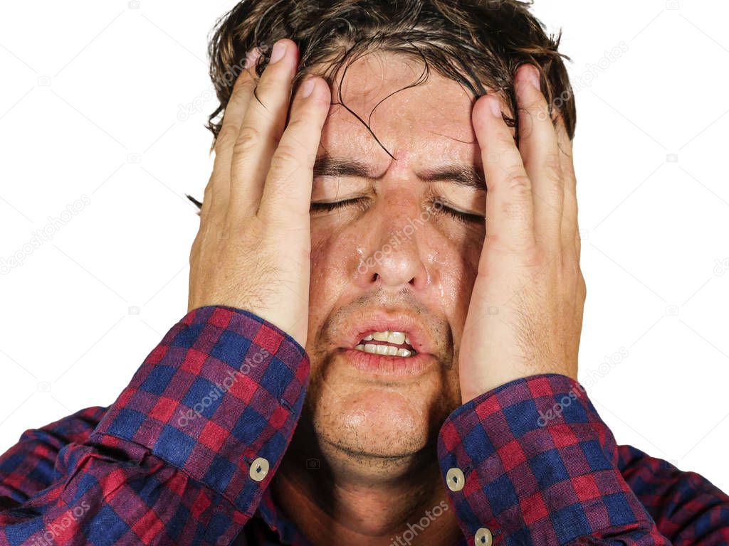 close up portrait of stressed and overwhelmed 30s or 40s man holding head with hands in crazy stress and frustrated face expression suffering problem feeling wasted 