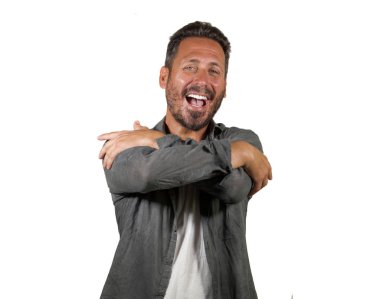 young happy and attractive man hugging himself smiling positive and charming doing hug gesture in self esteem and self confidence concept isolated on white