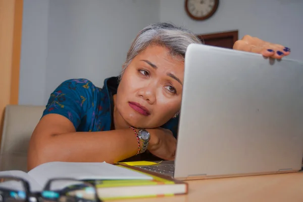 Депресія і перевантажений середнього віку привабливою азіатській жінці, що працюють у стрес на портативний комп'ютер стіл почуття засмутився і перевантажені в розлад обличчя вираз — стокове фото