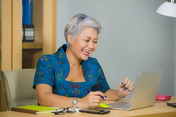 Vonzó és boldog sikeres középkorú üzleti ázsiai nő dolgozik a laptop számítógép asztal mosolygós magabiztos a vállalkozó ünneplő siker — Stock Fotó