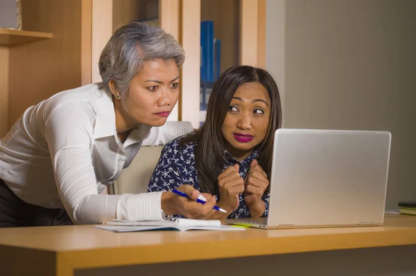 upset business woman nagging and scolding on employee girl angry for computer mistake in office boss or chief authority and assistant suffering reprimand