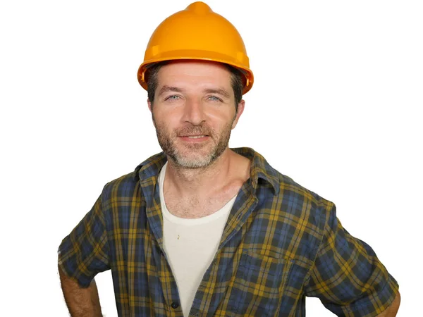 Corporate portrait of construction worker - Handsome and confident builder man in safety helmet smiling happy posing relaxed as successful contractor or handyman Royalty Free Stock Photos