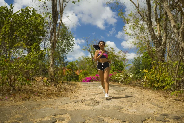 Unga attraktiva och exotiska asiatiska indonesiska löpare kvinna i jogging Workout utomhus på landsbygden Road Track naturen kör svettig trycka hårt — Stockfoto