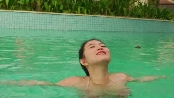 自然的生活方式拍摄年轻快乐和美丽的亚洲韩国女人在比基尼和包子享受夏季度假在豪华酒店度假村游泳池欢快和无忧无虑 — 图库视频影像