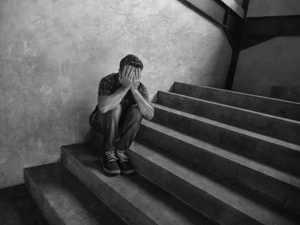 Desperate man sitting outdoors on dark grunge street corner staircase feeling sick suffering depression problem and anxiety crisis in mental health concept — Stock Photo, Image