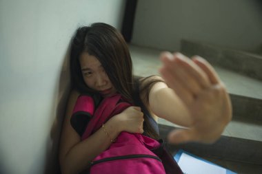 Genç güzel depresif Asya Çinli üniversite öğrencisi istismar duygu kampüs merdivenkurbanı oturan korkmuş ve yalnız taciz ve zorbalık olma