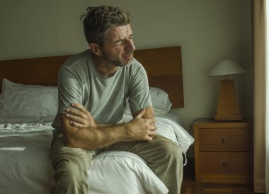30'lardan 40'lı ve 40'lı arası dramatik yaşam tarzı portresi yatakta üzgün oturan endişeli ve umutsuz acı depresyon sorunu