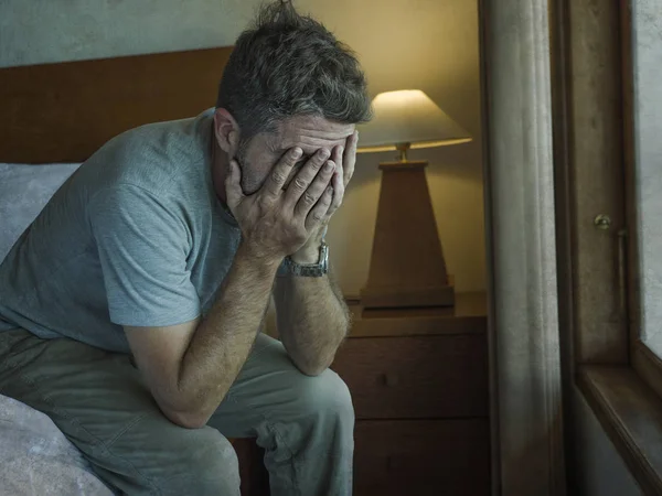 Dramatisches Lebensstil-Porträt eines Mannes, der deprimiert auf dem Bett sitzt und verzweifelt weint und traurig leidet unter Angstkrise und Depressionsproblem — Stockfoto