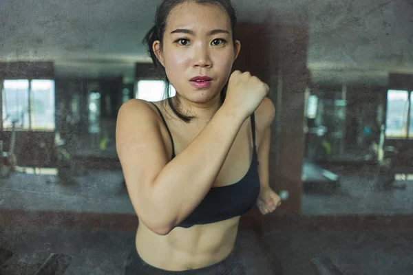 Young attractive and fit Asian Korean woman doing running workout at hotel gym or fitness club jogging in treadmill training hard in healthy lifestyle and body care — Stock Photo, Image