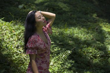 genç güzel ve mutlu Asyalı Çinli kadın şık elbise macera tatil gezisi zevk tropikal ada ormanda taze ve rahat duygu doğakeşfetmek