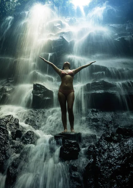 Natural portrait of young beautiful and happy Asian Korean woman in bikini enjoying nature at tropical paradise waterfall with magical feeling in soul inspiration — Stock Photo, Image