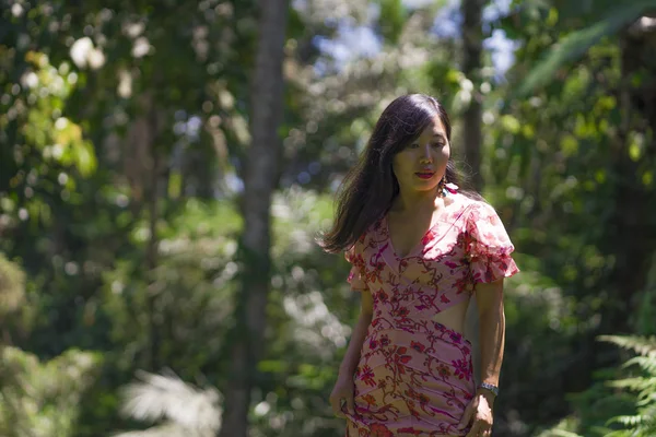 Al aire libre Estilo de vida de verano retrato de la joven hermosa y feliz mujer china asiática en vestido elegante caminando tranquilo y alegre en el parque verde de la ciudad o madera — Foto de Stock