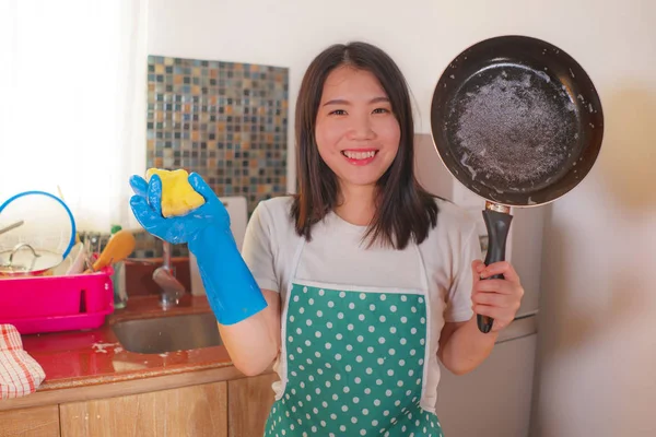 Retrato de estilo de vida natural de jovem bela e feliz mulher asiática coreana em avental e luva de borracha lavar pratos e pan sorridente alegre em tarefas domésticas relaxadas e tarefas domésticas — Fotografia de Stock