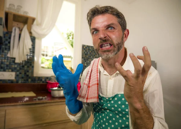 Unglücklicher und gestresster Mann in Küchenschürze, der sich frustriert und aufgebracht fühlt, überwältigt von häuslicher Arbeit, die Geschirr spült, müde schreiend, verzweifelt im Stress — Stockfoto