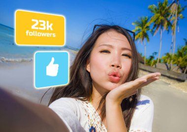 young beautiful and happy influencer Korean woman taking self portrait getting likes and new followers in travel blogger success