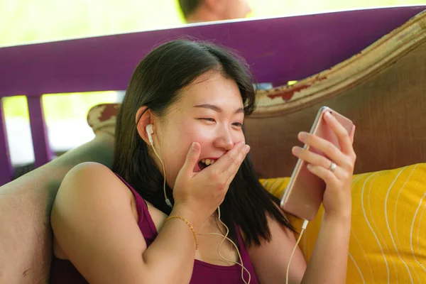 Bela menina estudante asiático-coreano feliz usando internet redes de aplicativos de mídia social com telefone mão ao ar livre no café legal sorrindo alegre internet namoro — Fotografia de Stock