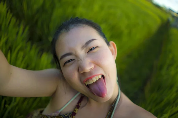 Jovem feliz e bela mulher asiática tirar foto selfie ao ar livre. menina coreana alegre em vestido de verão tomando auto retrato no campo verde desfrutando de viagens de férias — Fotografia de Stock