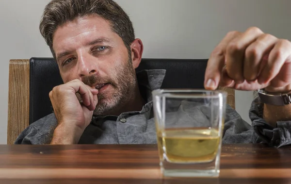 Alkol bağımlılığı ve alkolizm sorununda içki içmenin cazibesine tutunarak 40 'lı yaşlarındaki depresif ve düşünceli alkolik bir adamın viski bardağının önünde sarhoş ve stresli bir şekilde durması. — Stok fotoğraf