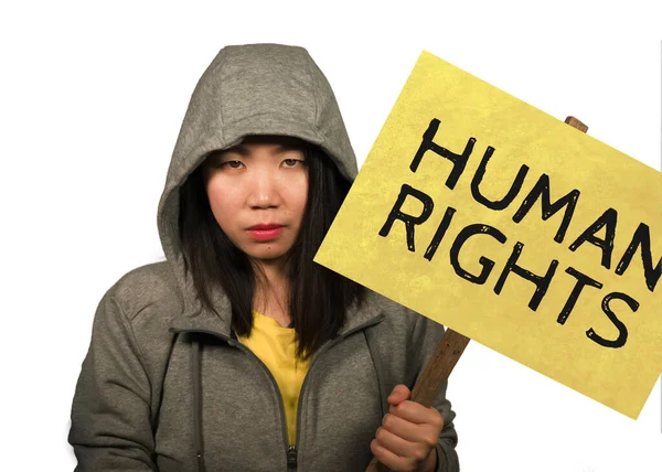 Young beautiful Asian Chinese student woman as protestor and pacifist holding protest billboard with human rights text against violence and discrimination isolated — Stock Photo, Image