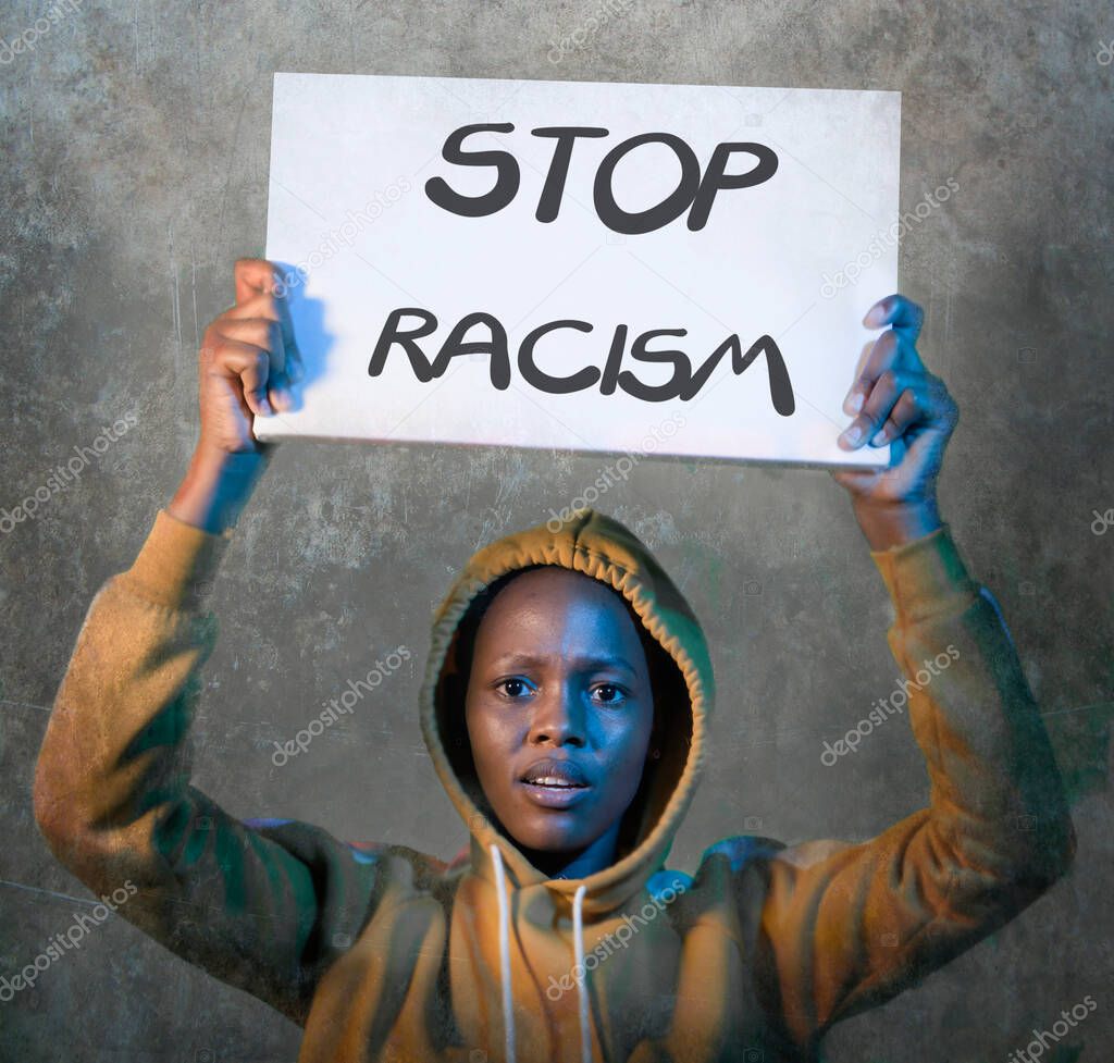 stop racism black activist girl protesting against government - young beautiful and furious afro American woman in hoodie showing protest banner demanding stop racial discrimination 