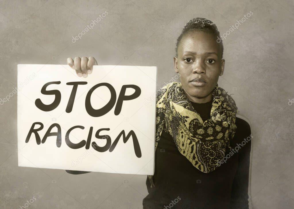 stop racism black activist girl protesting against government - young outraged and hipster African American woman showing protest banner demanding stop racial discrimination 
