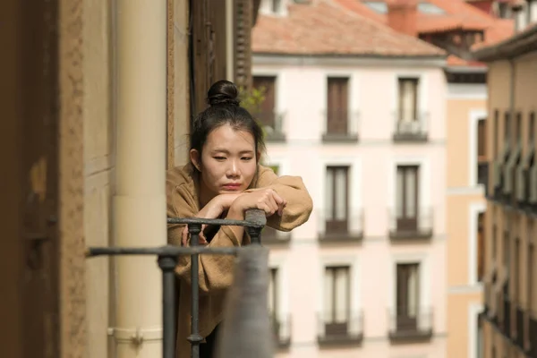 dramatic portrait of young beautiful sad and depressed Asian Chinese woman feeling unhappy and worried suffering some problem going through depression and anxiety crisis