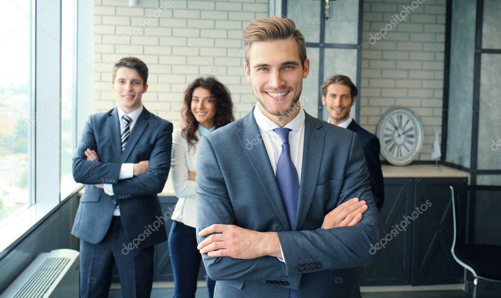 Businessman with colleagues in the background in office