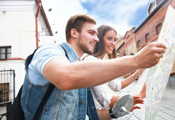 Young Couple with scooter looking at map