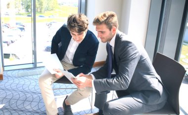 Dijital tablet kullanma ve modern işyeri Bürosu meslektaşınızın bilgilerle tartışırken iş adamı