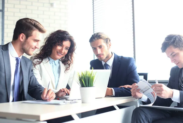 Startup business team on meeting in modern bright office interior and working on laptop. — Stock Photo, Image