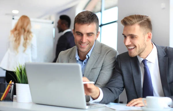 Startup business team on meeting in modern bright office interior and working on laptop. — Stock Photo, Image