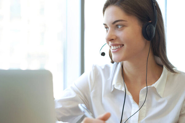 Customer support operator working in a call center office.