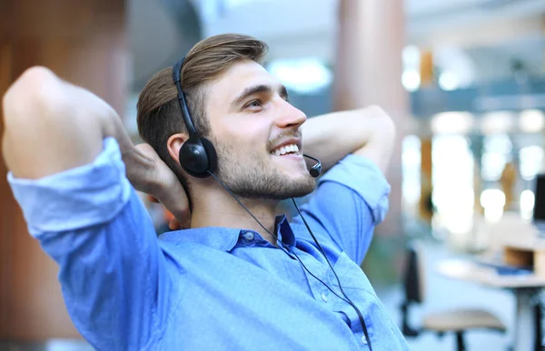 Call center operator in headset resting at workplace in office. — Stock Photo, Image