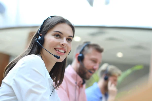 Jovens empresários e colegas atraentes e positivos em um escritório de call center. — Fotografia de Stock