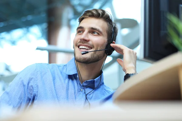 Freundlich lächelnde hübsche junge männliche Callcenter-Betreiber. — Stockfoto
