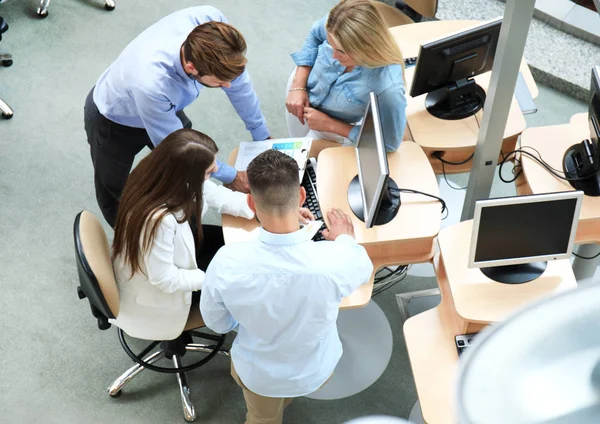 stock image Top view of young modern colleagues in smart casual wear working together while spending time in the office.