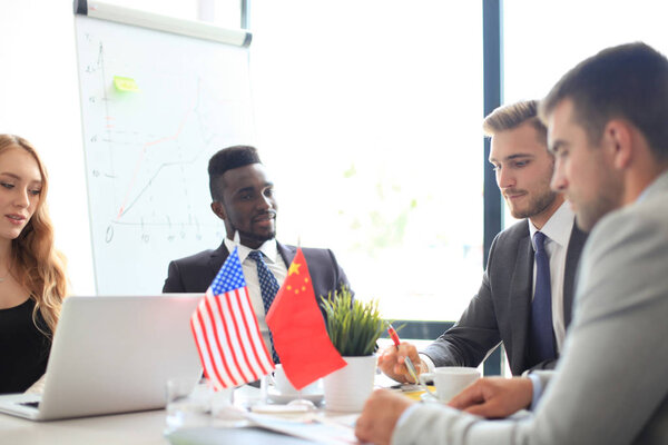 Разнообразие людей говорят о международной конференции партнерства. Американский флаг и китайский флаг
.