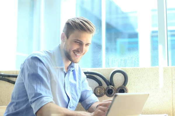 Portrait de jeune homme utilisant une tablette au bureau . — Photo