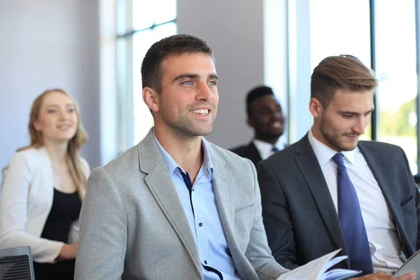 Grupo de hombres de negocios sentados en conferencia a discurso durante una reunión de negocios . — Foto de Stock