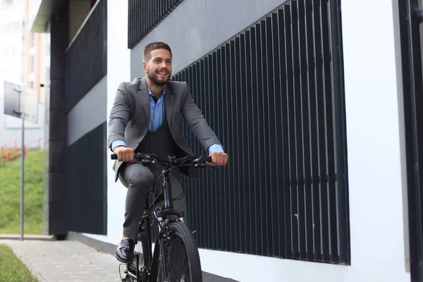 Όμορφος νεαρός επιχειρηματίας ιππασία ποδήλατο σε εξωτερικούς χώρους στην πόλη. — Φωτογραφία Αρχείου